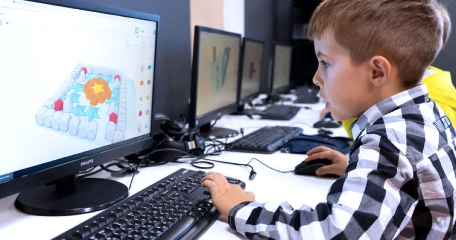 A child playing an educational game on a computer. 