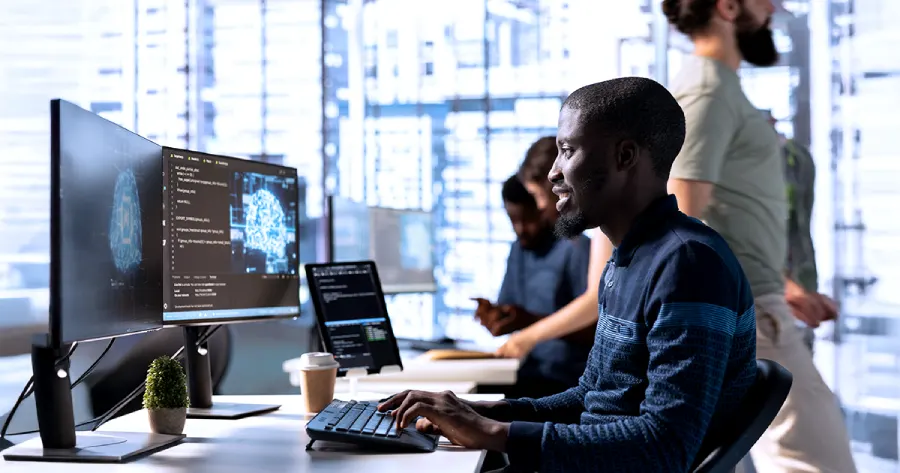 A software professional at a modern workstation, using AI-powered tools and structured workflows to support AI content transformation across digital learning and content development projects.