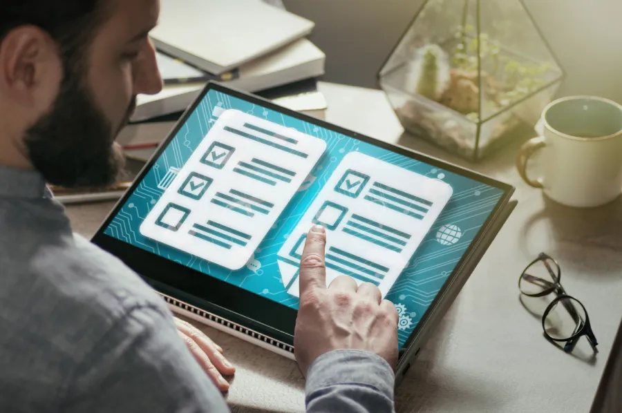 A working professional uses a tablet displaying digital assessment forms with checkboxes and answer fields, highlighting assessment platform modernization for online testing and evaluation.